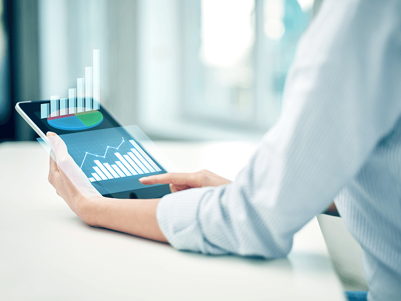 woman on iPad reviewing current business value prediction charts