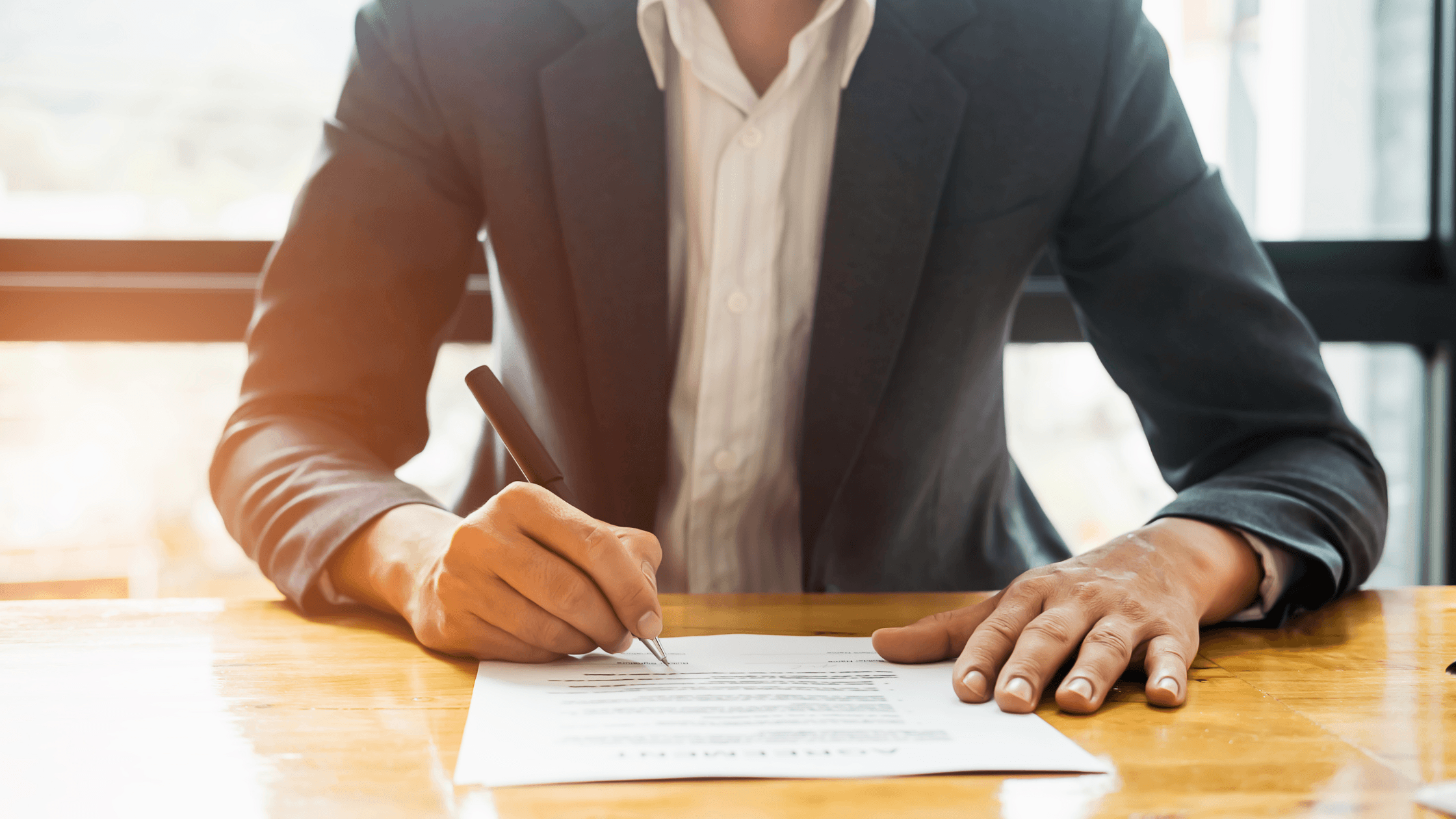 Business owner signing a confidentiality agreement before sharing financial information with a prospective buyer