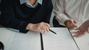 Business advisor and seller reviewing an earnout agreement in a business sale contract