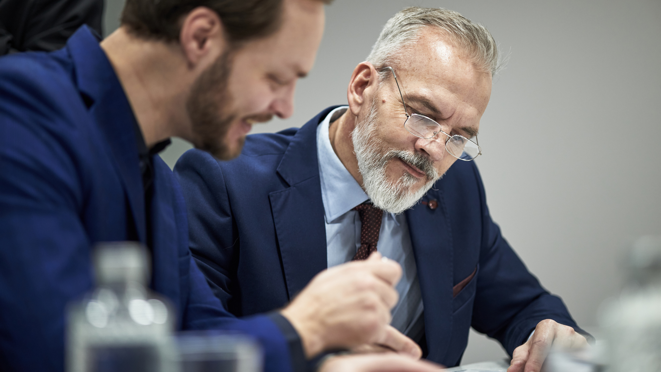 Business partners reviewing a buy-sell agreement document together