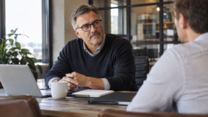Business owner discussing a letter of intent with a potential buyer over coffee